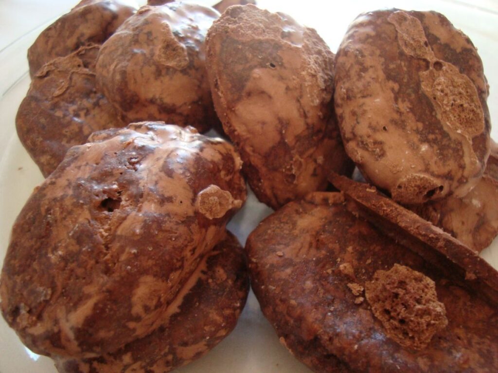 Apulian mostaccioli biscuits covered in chocolate glaze, on a plate