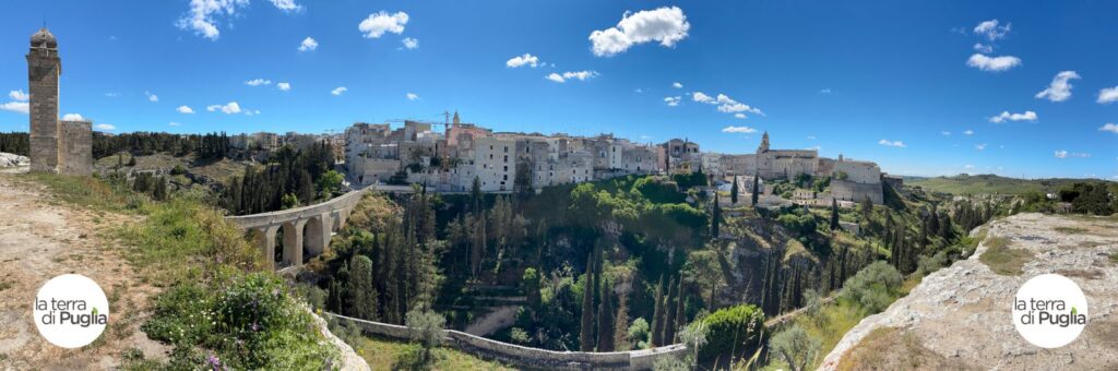 Panorama of Gravina in Puglia on the edge of its ravine, with the aqueduct bridge and the old town