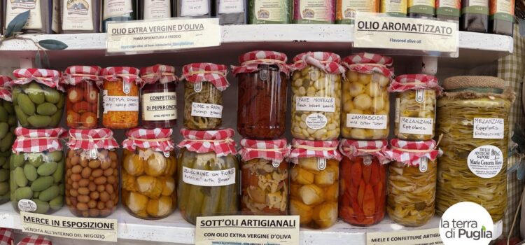 A shelf of Apulian artisan preserves: vegetables in oil, olives and extra virgin olive oil