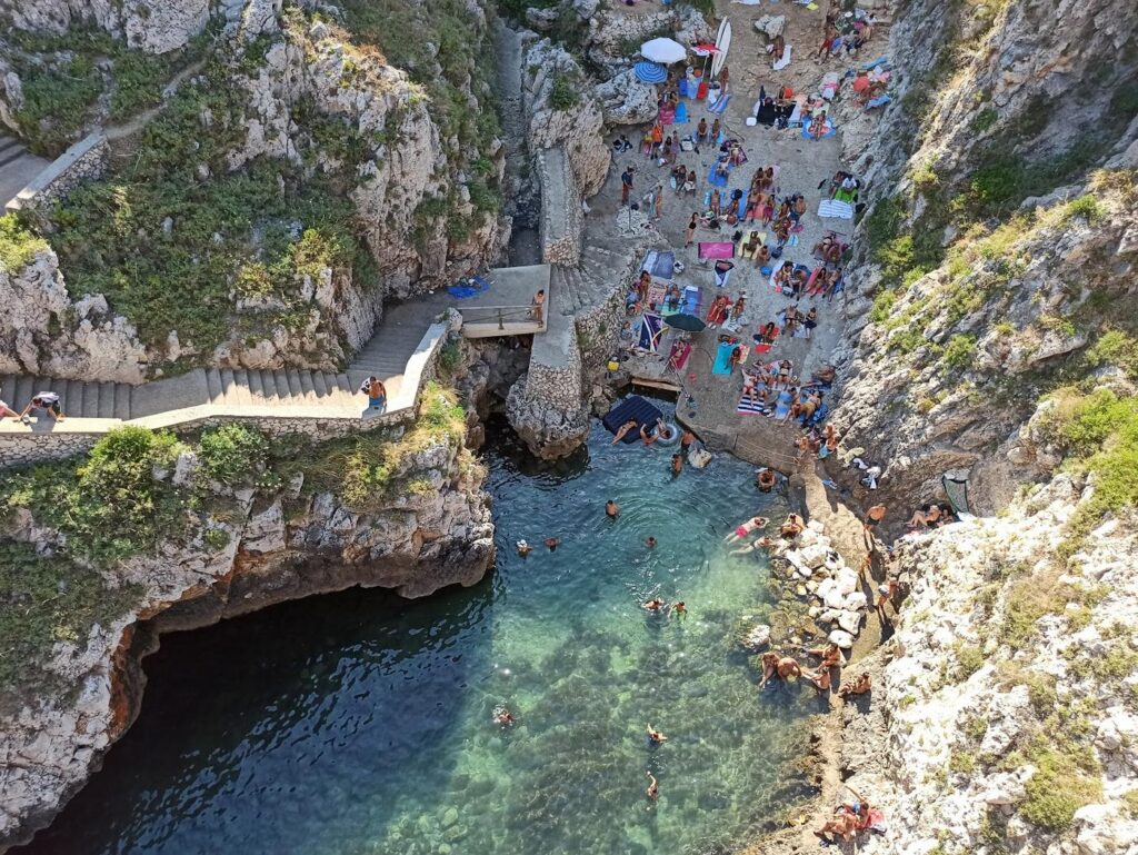 The little beach at the Ciolo at the foot of the steps, below the cliffs