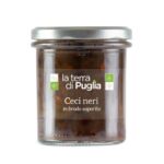 A glass jar of black chickpeas in broth with the La Terra di Puglia label