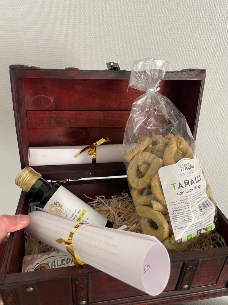 The wooden gift chest prepared in Metz by Giovanni of Casa Giulia for Pope Leo XIV, with a bag of La Terra di Puglia taralli with turnip tops