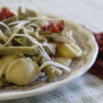 A plate of orecchiette, the Apulian ear-shaped pasta, with artichokes, sun-dried tomatoes and grated cheese
